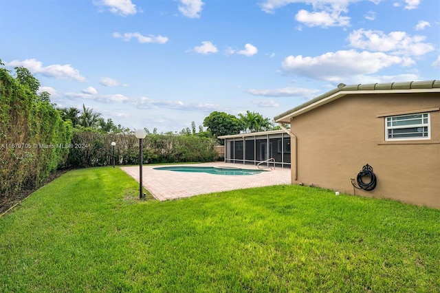 exterior space featuring a yard, a patio area, and a sunroom