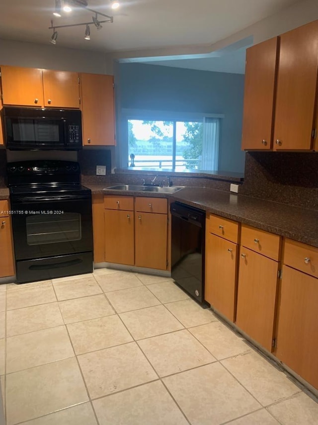 kitchen with black appliances, light tile patterned flooring, sink, and tasteful backsplash