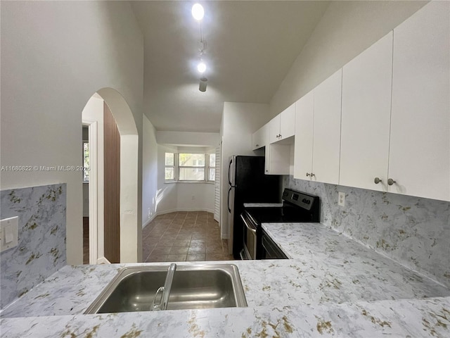 kitchen with white cabinets, stainless steel range with electric stovetop, and sink