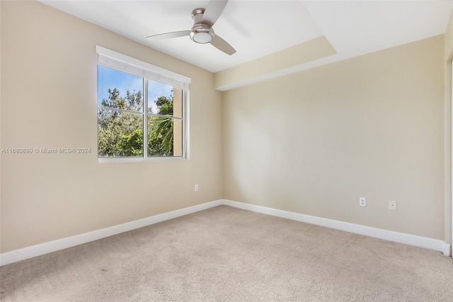 spare room featuring ceiling fan and carpet