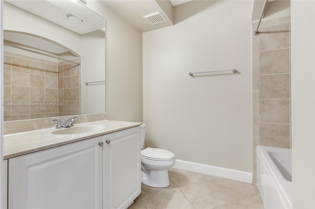 full bathroom with vanity, tiled shower / bath combo, toilet, and tile patterned flooring