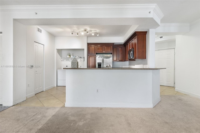 kitchen featuring light colored carpet, ornamental molding, stainless steel appliances, and dark stone counters