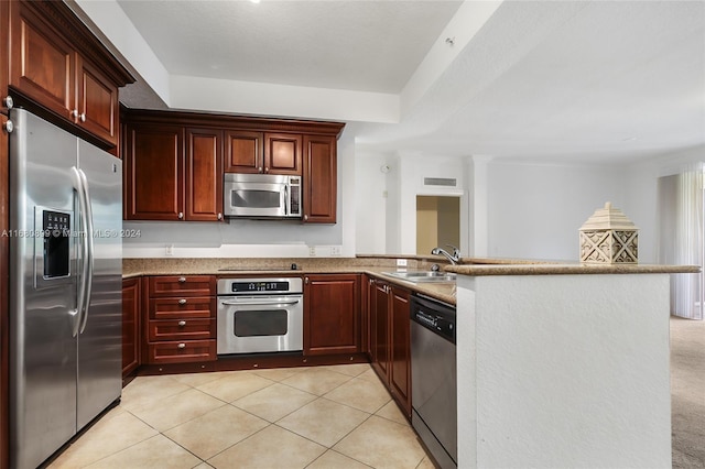 4 Renaissance Way Unit 303, Boynton Beach, FL 33426 - kitchen with stainless steel appliances, a sink, a peninsula, light tile patterned flooring, and dark brown cabinets