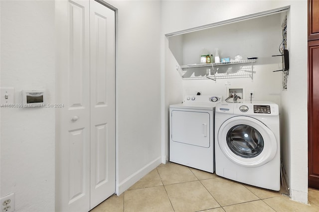 laundry room with light tile patterned flooring and separate washer and dryer