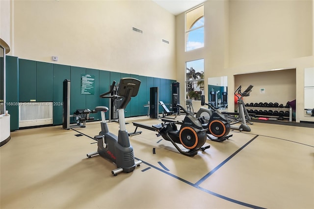 gym with a towering ceiling