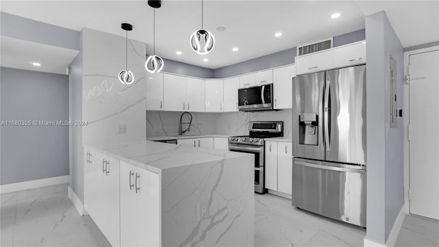 kitchen with kitchen peninsula, hanging light fixtures, white cabinetry, light stone countertops, and stainless steel appliances