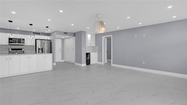 kitchen with decorative backsplash, wine cooler, appliances with stainless steel finishes, white cabinetry, and pendant lighting