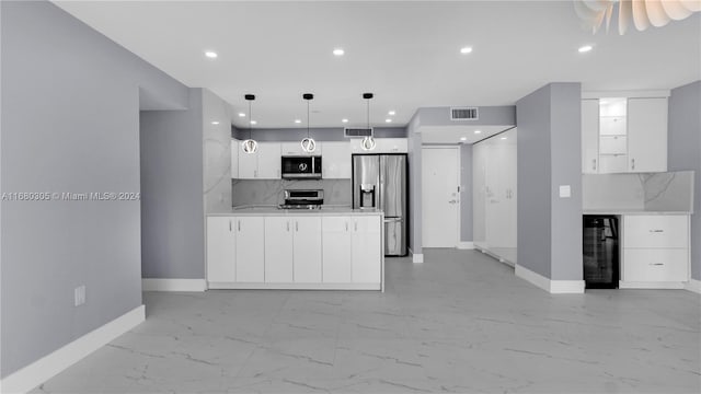 kitchen with wine cooler, white cabinets, tasteful backsplash, hanging light fixtures, and stainless steel appliances