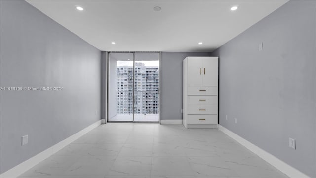 spare room featuring floor to ceiling windows