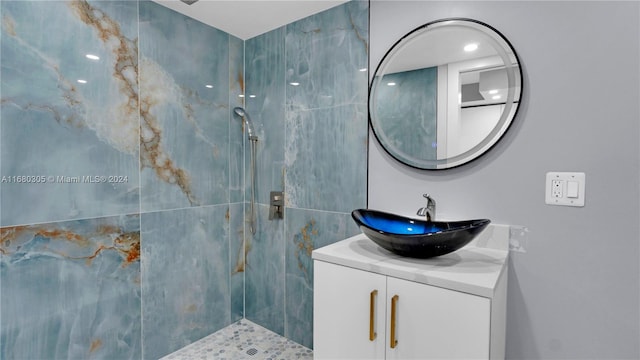 bathroom featuring vanity and tiled shower