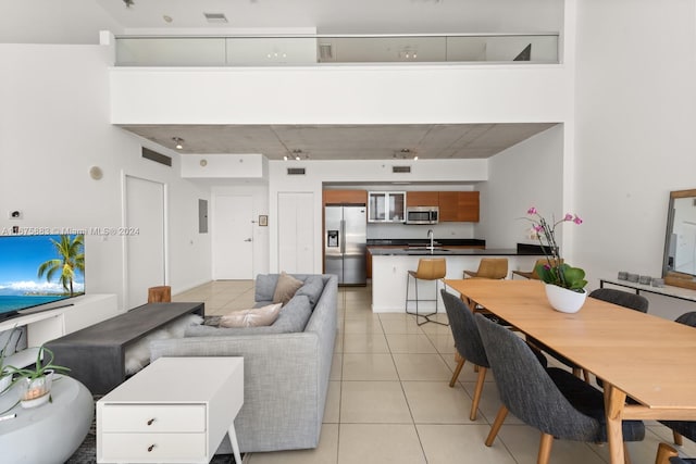 living room with sink and light tile patterned floors