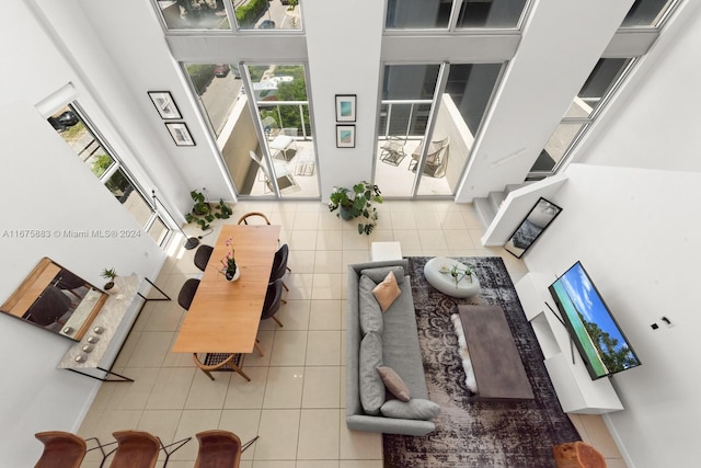 tiled living room featuring a high ceiling