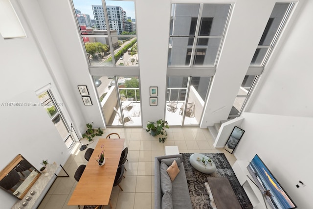 tiled living room with a high ceiling