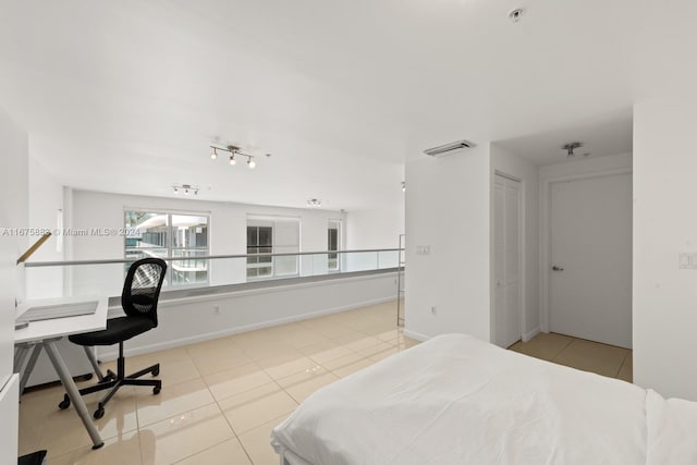 bedroom featuring light tile patterned flooring and a closet