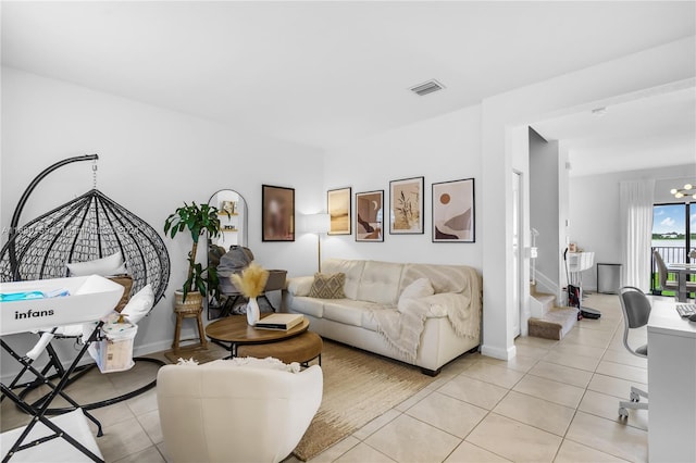 living room featuring a notable chandelier and light tile patterned floors