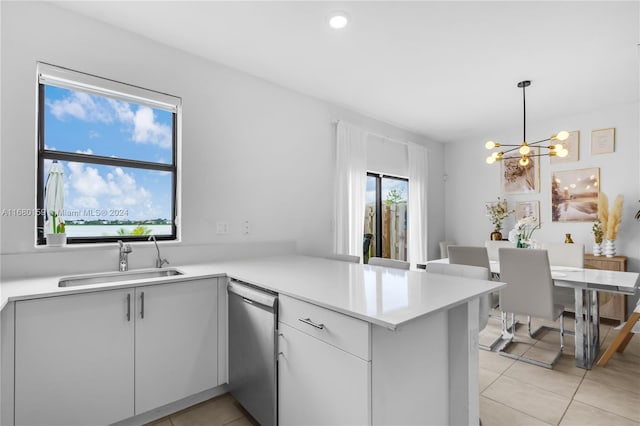 kitchen featuring sink, light tile patterned flooring, dishwasher, kitchen peninsula, and hanging light fixtures