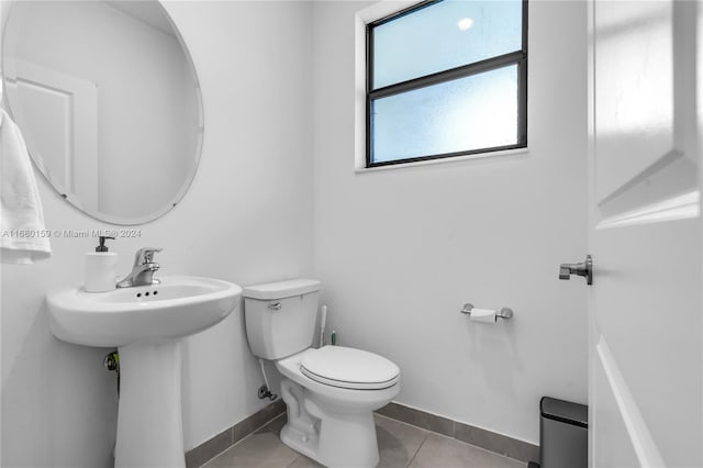 bathroom with toilet and tile patterned floors