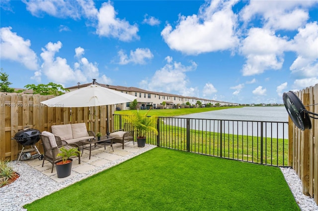 view of yard with a water view and a patio area