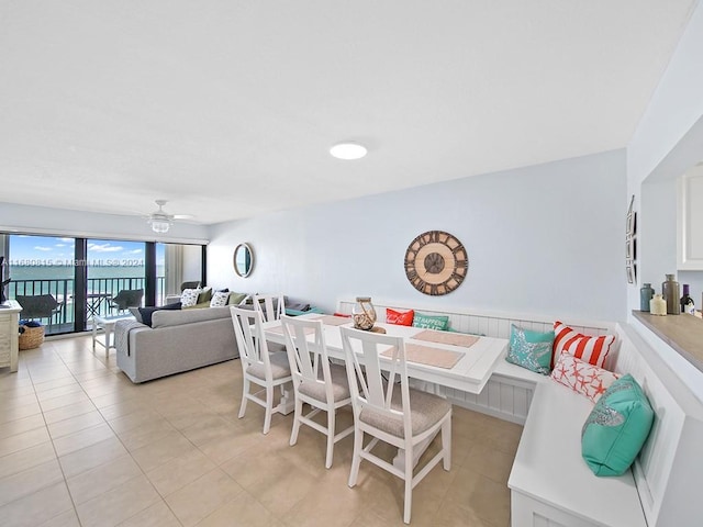 dining space with ceiling fan, breakfast area, and light tile patterned flooring