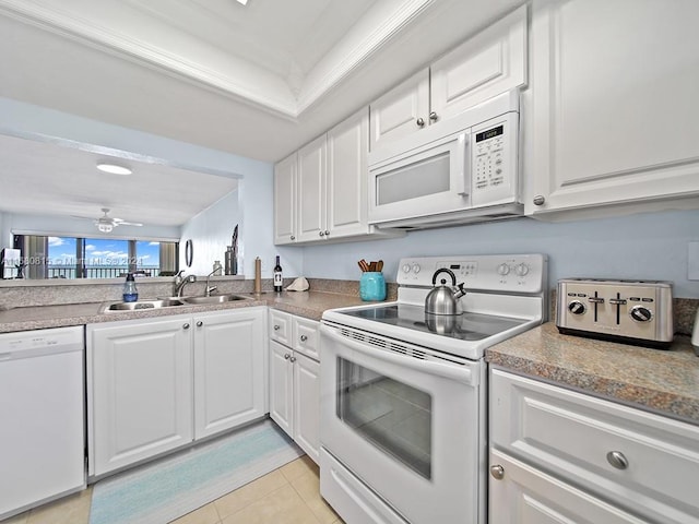 kitchen with white appliances, white cabinets, sink, ceiling fan, and light tile patterned floors