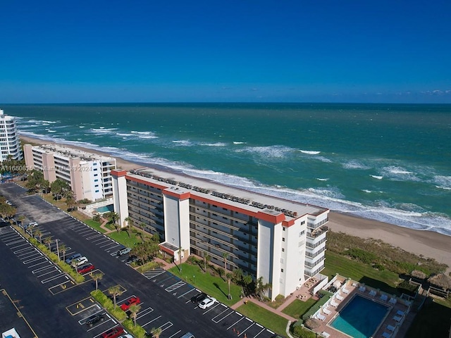 drone / aerial view with a water view and a view of the beach