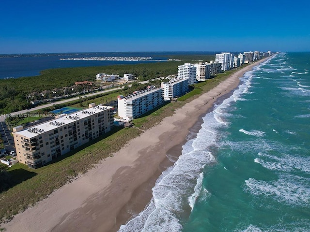 aerial view featuring a water view and a beach view