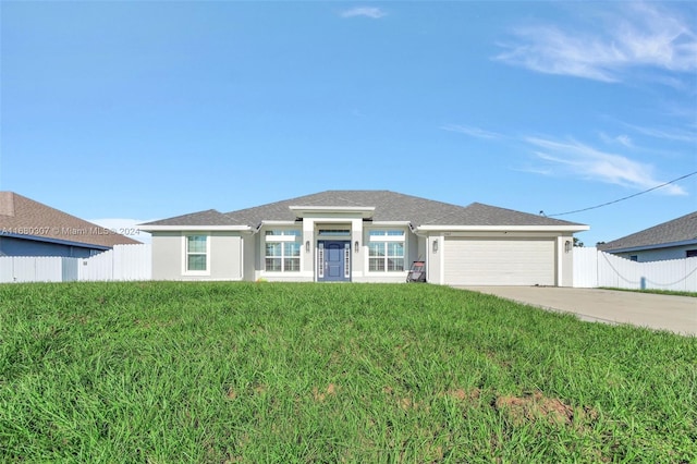 view of front of home with a front yard and a garage