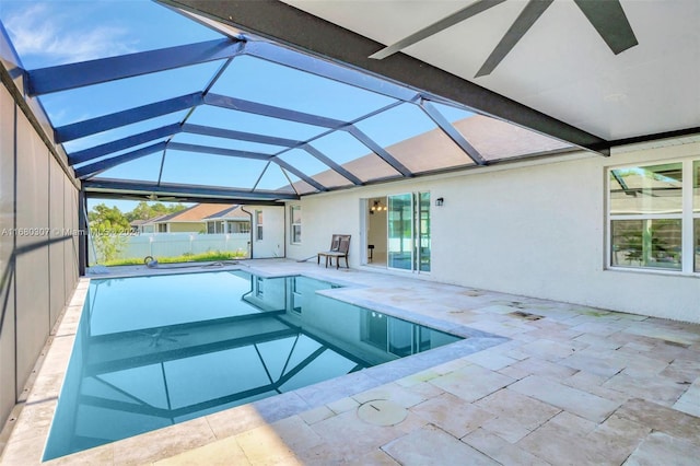 view of swimming pool featuring a patio area and a lanai