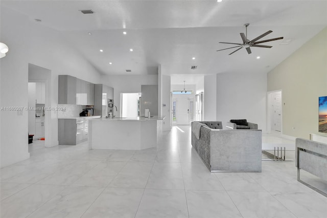 living room with ceiling fan and high vaulted ceiling