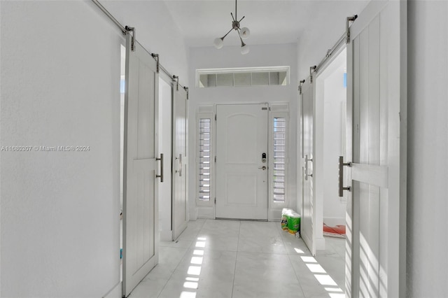 tiled entrance foyer featuring a barn door