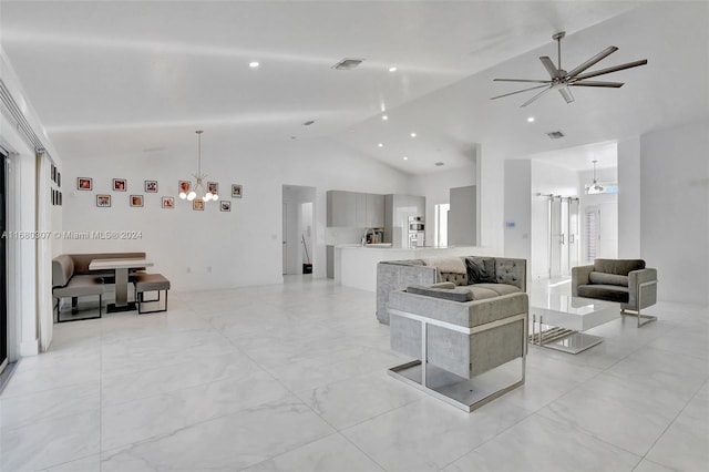 living room featuring high vaulted ceiling and ceiling fan with notable chandelier