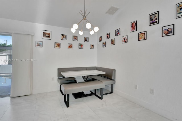 dining room with a chandelier and high vaulted ceiling