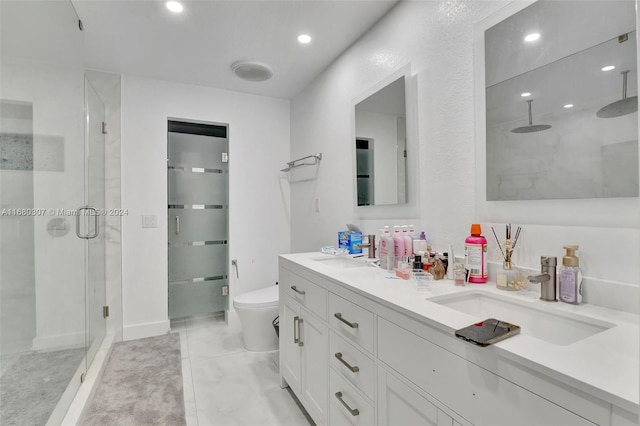 bathroom with toilet, an enclosed shower, and vanity