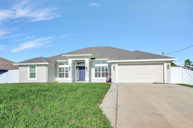 view of front of house featuring a front yard and a garage