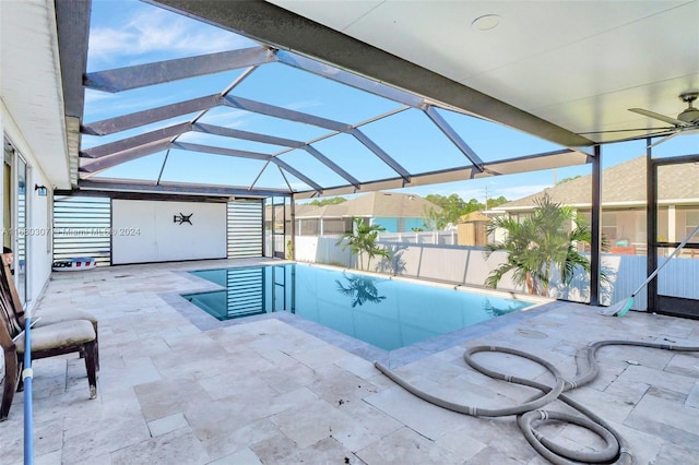 view of swimming pool featuring a patio area, a lanai, and ceiling fan