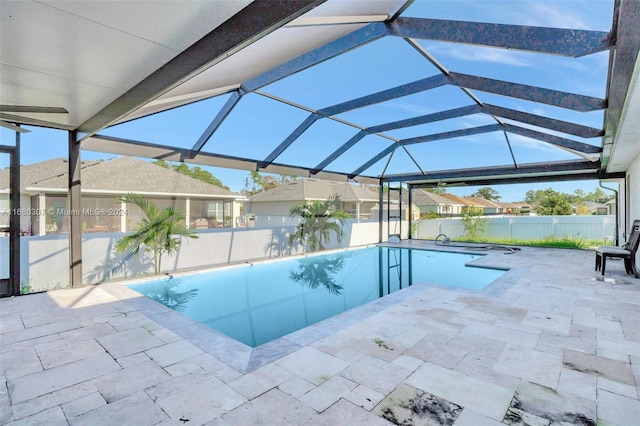 view of pool with a patio and a lanai