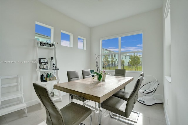 dining area featuring light tile patterned flooring