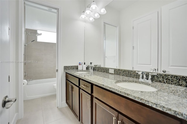 full bathroom featuring tile patterned floors, vanity, toilet, and tiled shower / bath