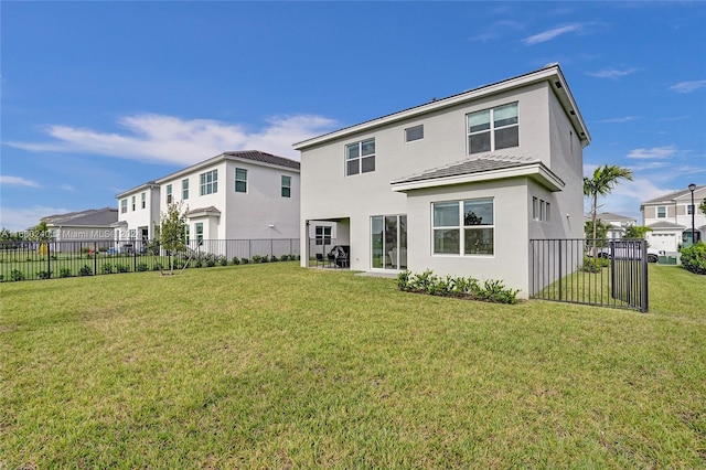 rear view of property featuring a lawn