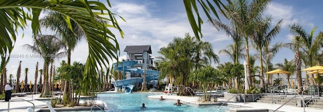 view of swimming pool with a water slide