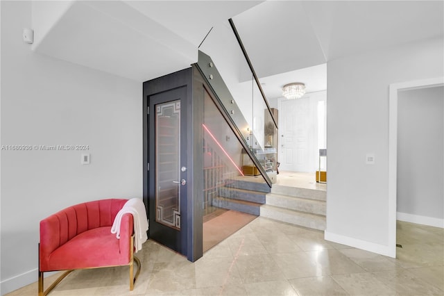 stairway with an inviting chandelier