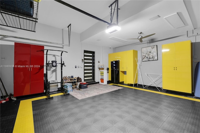 garage featuring black refrigerator and ceiling fan