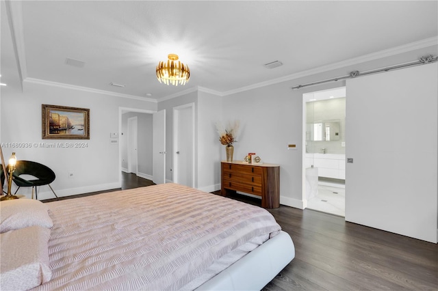 bedroom with ensuite bathroom, a barn door, dark hardwood / wood-style flooring, a notable chandelier, and ornamental molding