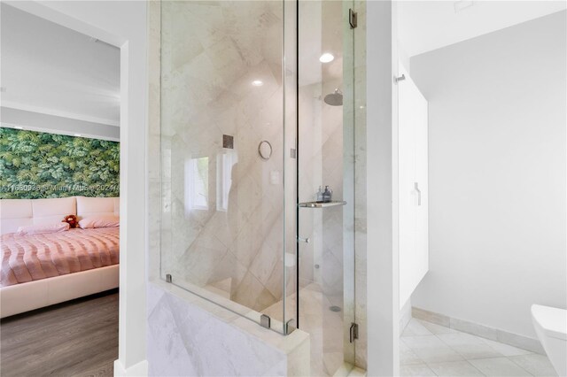 bathroom featuring a shower with door, breakfast area, and wood-type flooring