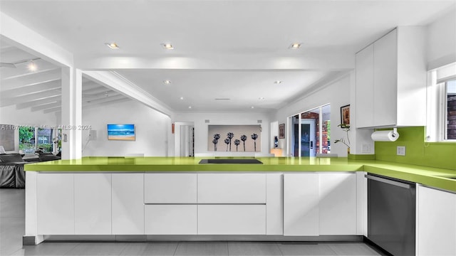 kitchen featuring light tile patterned flooring, white cabinetry, lofted ceiling with beams, and stainless steel dishwasher