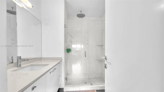 bathroom featuring vanity and an enclosed shower