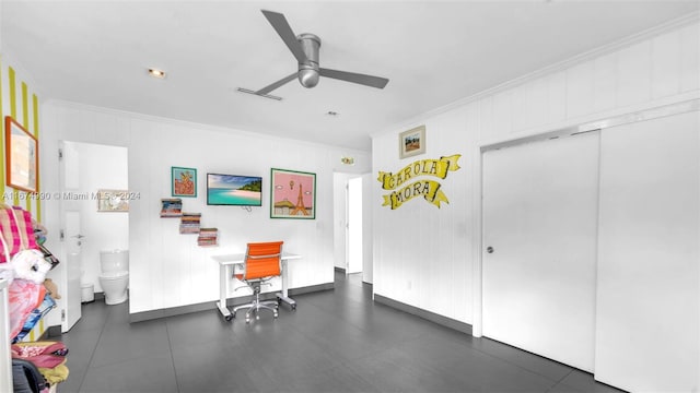 interior space featuring built in desk, crown molding, and ceiling fan