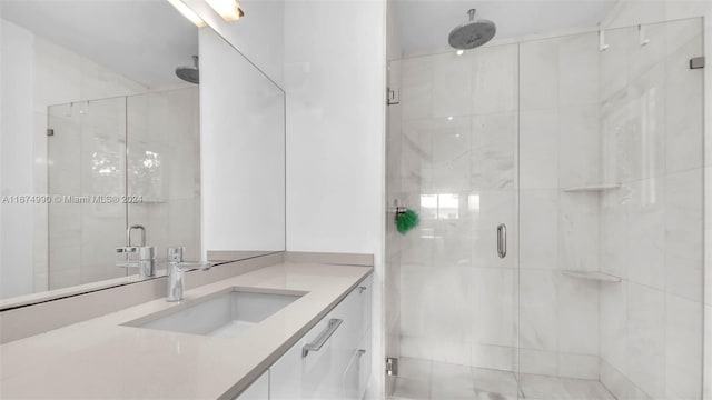 bathroom featuring vanity and a shower with shower door