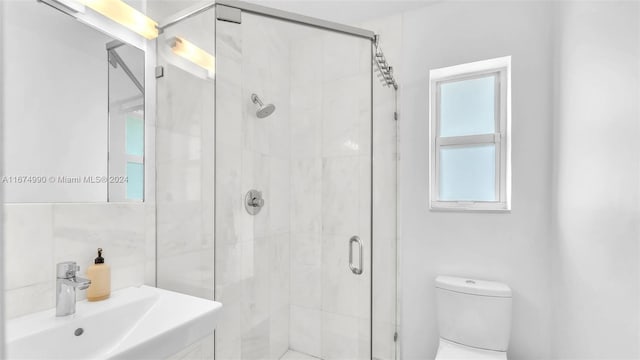 bathroom with vanity, a shower with shower door, and toilet