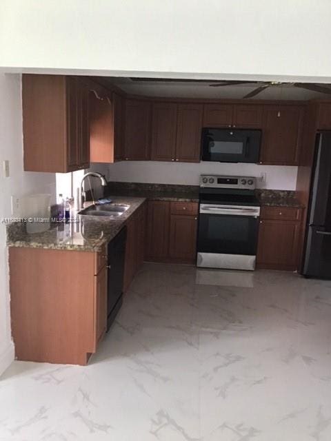 kitchen featuring black appliances, sink, and dark stone counters